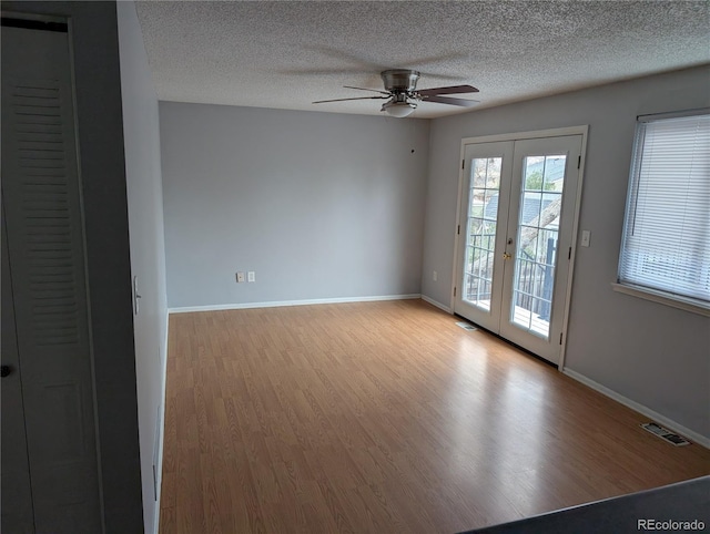 220 Mckinley Dr, Bennett, CO 80102 - empty room with ceiling fan, visible vents, french doors, and wood finished floors