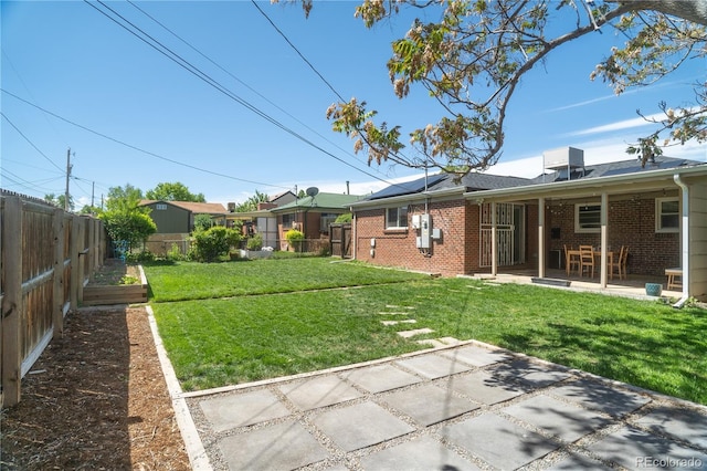 view of yard with a patio and a vegetable garden
