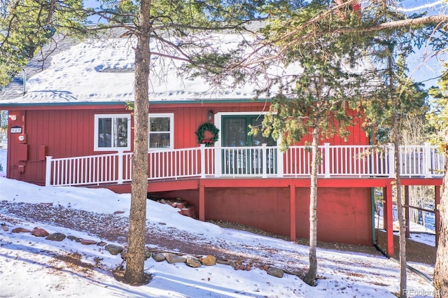 snow covered property featuring a deck