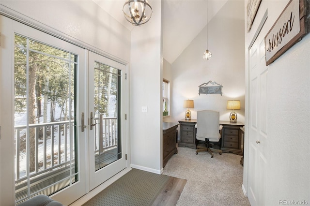 carpeted office with vaulted ceiling and french doors