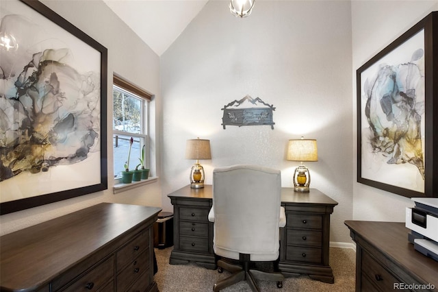 carpeted office space with vaulted ceiling