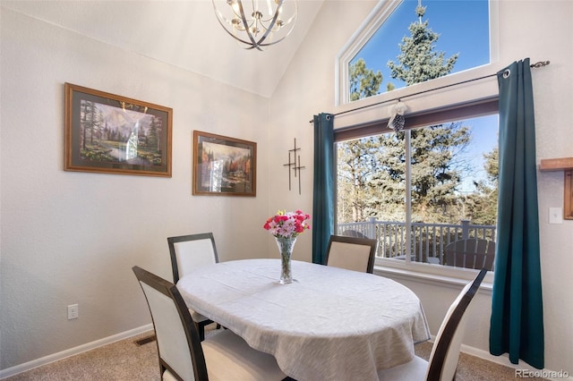 carpeted dining room with high vaulted ceiling and a chandelier