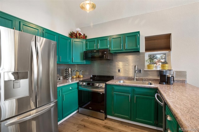 kitchen with light hardwood / wood-style floors, sink, backsplash, stainless steel appliances, and lofted ceiling