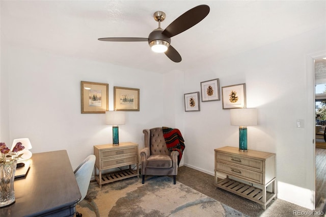 sitting room with ceiling fan and carpet floors