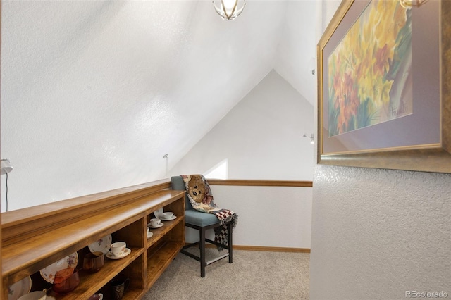 interior space with lofted ceiling and light carpet