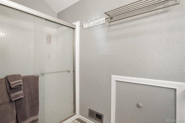 bathroom featuring lofted ceiling