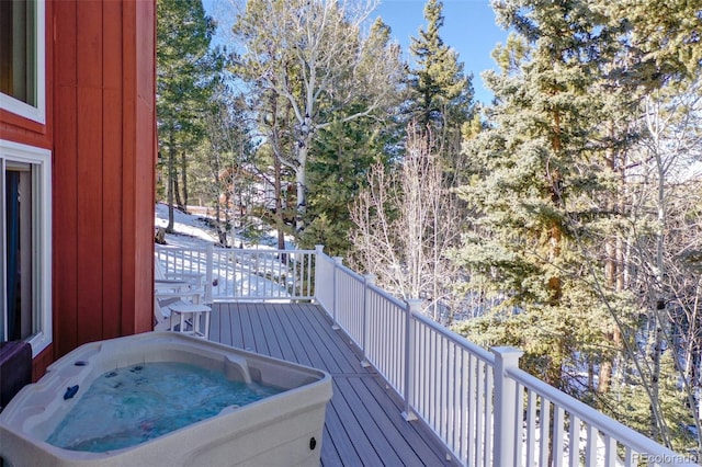 wooden deck featuring an outdoor hot tub