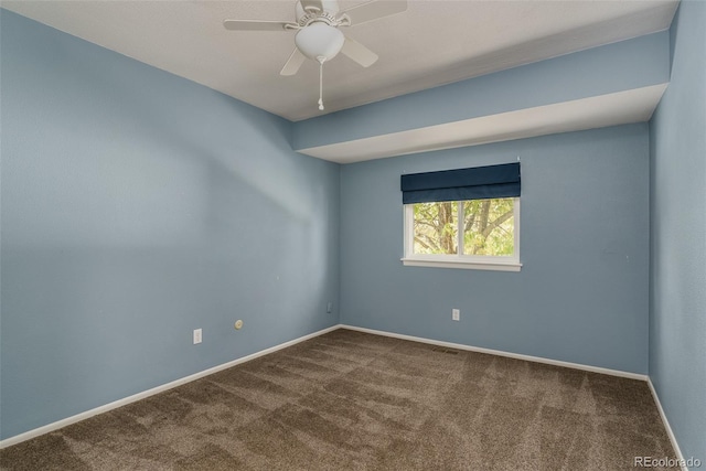 spare room featuring ceiling fan and carpet floors