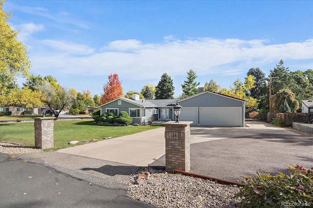 ranch-style home featuring a front yard, concrete driveway, a garage, and fence