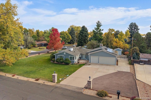 34 Skyline Dr, Wheat Ridge, CO 80215 - ranch-style home featuring concrete driveway, an attached garage, and roof mounted solar panels