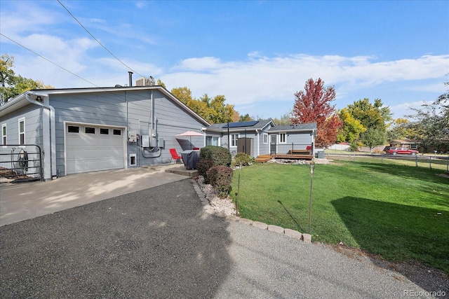 34 Skyline Dr, Wheat Ridge, CO 80215 - ranch-style home featuring asphalt driveway, a deck, roof mounted solar panels, and a garage