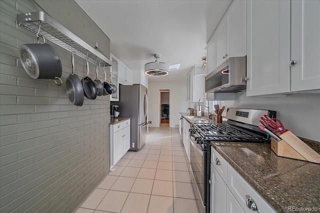 34 Skyline Dr, Wheat Ridge, CO 80215 - kitchen with stainless steel appliances, a sink, light tile patterned floors, and white cabinets
