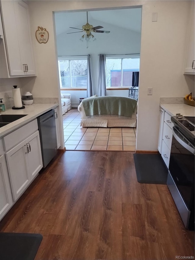 245 Lower Glenway St, Palmer Lake, CO 80133 - kitchen featuring appliances with stainless steel finishes, white cabinets, dark wood-style floors, light countertops, and lofted ceiling