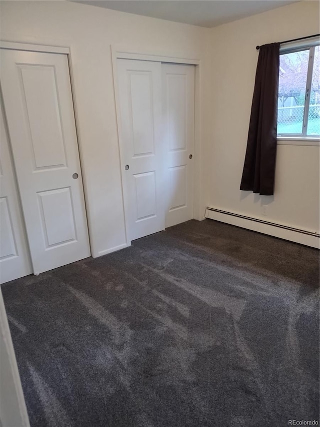 245 Lower Glenway St, Palmer Lake, CO 80133 - unfurnished bedroom with baseboard heating and dark carpet