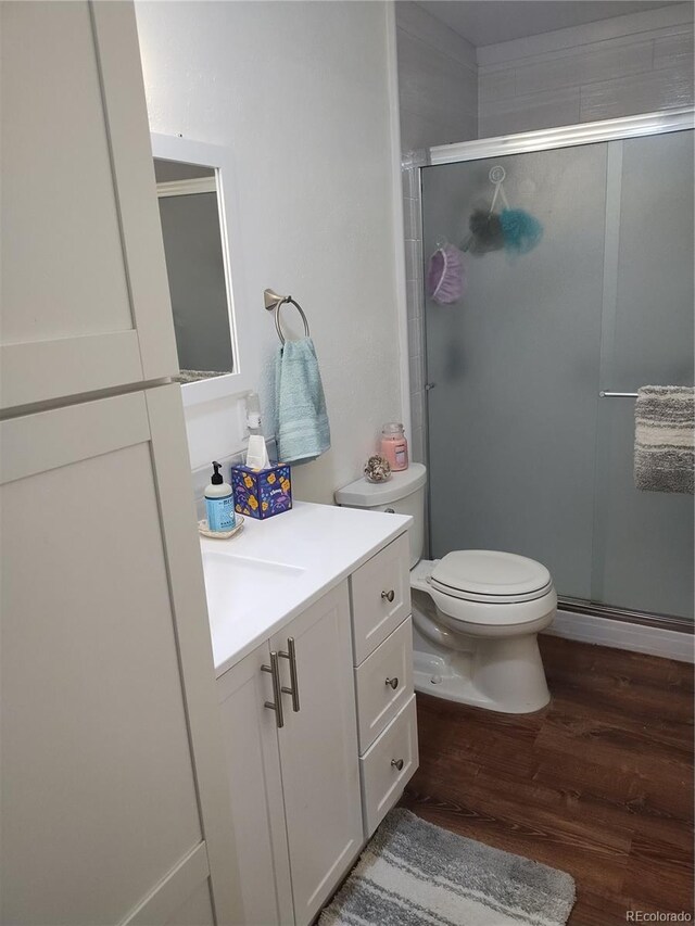 245 Lower Glenway St, Palmer Lake, CO 80133 - full bath with wood finished floors, vanity, and a shower stall