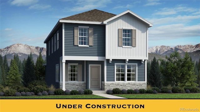 834 N Bently St, Watkins, CO 80137 - view of front facade with a mountain view, stone siding, and board and batten siding