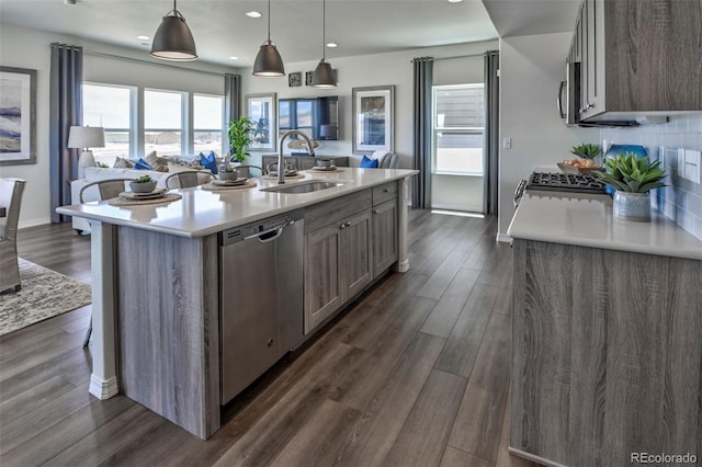 834 N Bently St, Watkins, CO 80137 - kitchen with stainless steel appliances, a sink, light countertops, dark wood-style floors, and recessed lighting