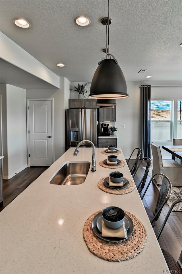 834 N Bently St, Watkins, CO 80137 - kitchen featuring a sink, stainless steel fridge with ice dispenser, a textured ceiling, dark wood finished floors, and recessed lighting