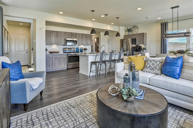 834 N Bently St, Watkins, CO 80137 - living area with dark wood finished floors and recessed lighting