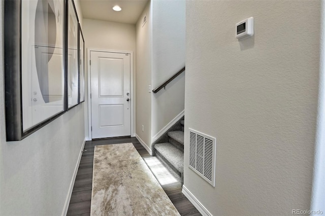 834 N Bently St, Watkins, CO 80137 - doorway with baseboards, stairway, dark wood-type flooring, recessed lighting, and a textured wall