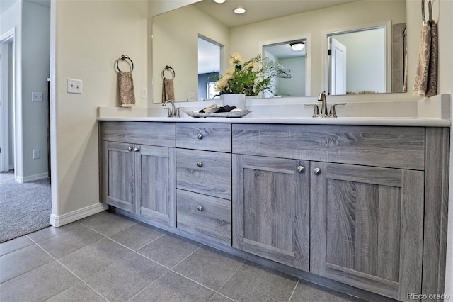 834 N Bently St, Watkins, CO 80137 - bathroom with double vanity, baseboards, tile patterned floors, and recessed lighting