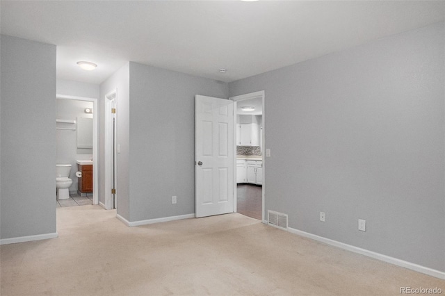 3600 S Pierce St Unit 2-201, Lakewood, CO 80235 - unfurnished bedroom with light colored carpet and ensuite bath