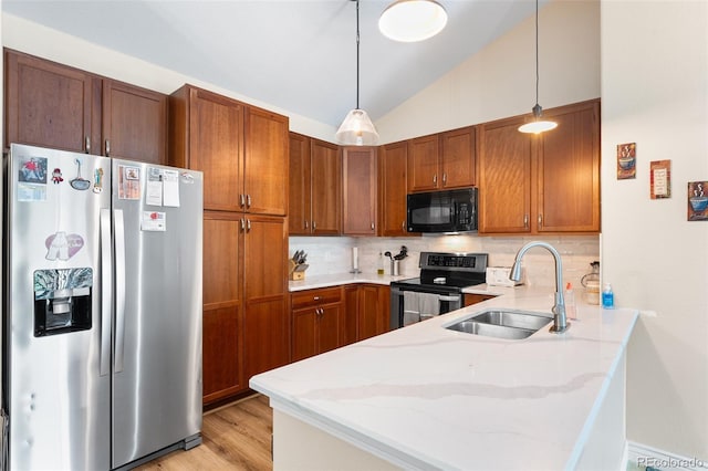 8779 S Kipling Way Unit 204, Littleton, CO 80127 - kitchen with appliances with stainless steel finishes, a sink, a peninsula, backsplash, and light stone counters
