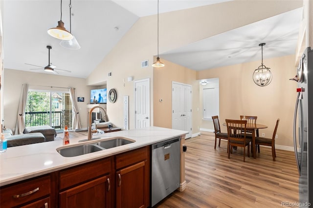 8779 S Kipling Way Unit 204, Littleton, CO 80127 - kitchen with stainless steel appliances, a sink, open floor plan, light countertops, and pendant lighting