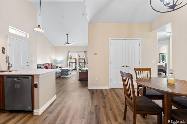8779 S Kipling Way Unit 204, Littleton, CO 80127 - dining area featuring wood finished floors, ceiling fan, high vaulted ceiling, baseboards, and a chandelier