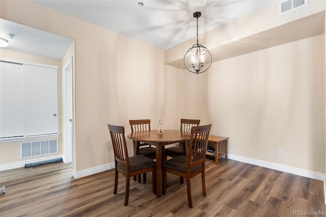 8779 S Kipling Way Unit 204, Littleton, CO 80127 - dining room with wood finished floors, a chandelier, and baseboards