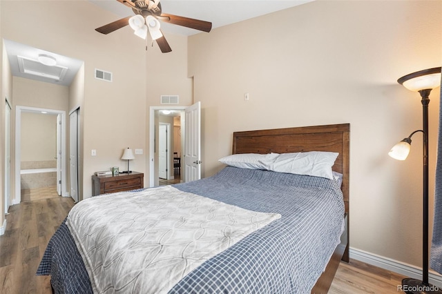 8779 S Kipling Way Unit 204, Littleton, CO 80127 - bedroom featuring attic access, wood finished floors, baseboards, ceiling fan, and ensuite bathroom
