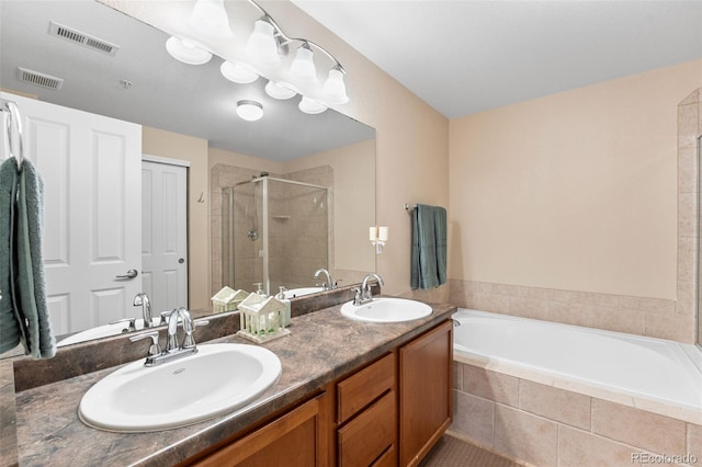 8779 S Kipling Way Unit 204, Littleton, CO 80127 - bathroom featuring a shower stall, a garden tub, and double vanity