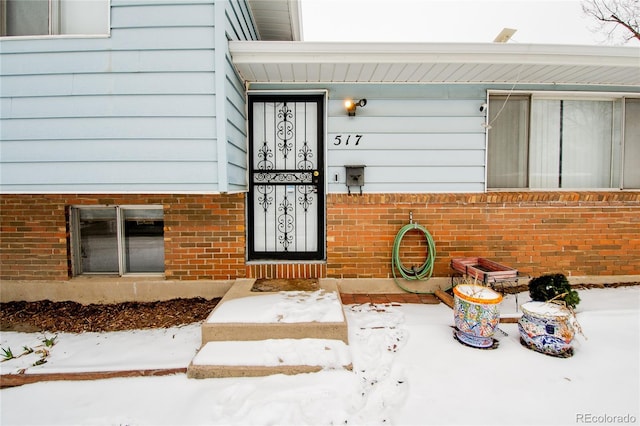 view of snow covered property entrance