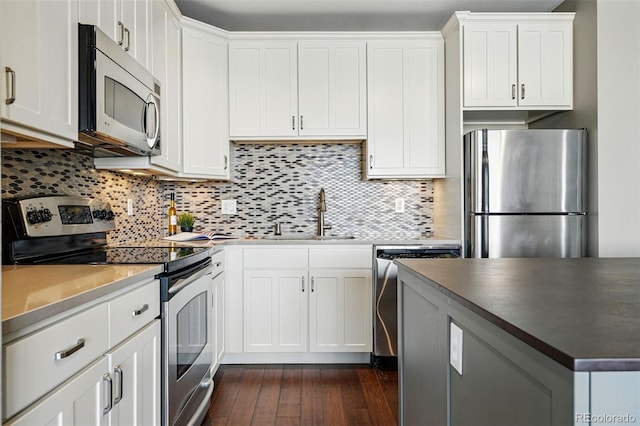 1950 N Logan St Unit 1109, Denver, CO 80203 - kitchen featuring appliances with stainless steel finishes, a sink, dark wood finished floors, and tasteful backsplash