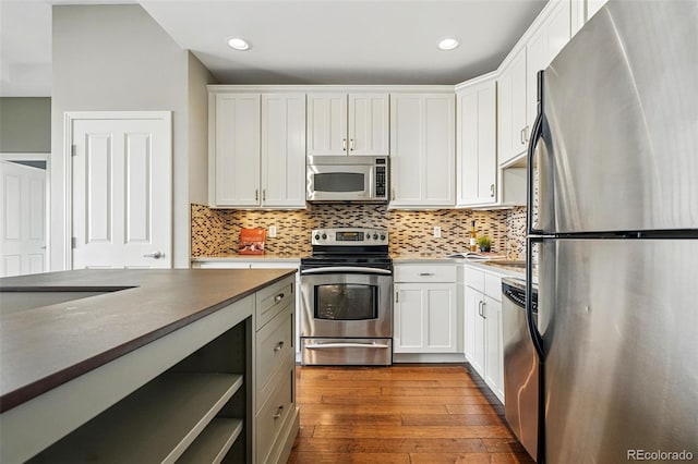 1950 N Logan St Unit 1109, Denver, CO 80203 - kitchen featuring appliances with stainless steel finishes, backsplash, white cabinets, dark wood finished floors, and recessed lighting