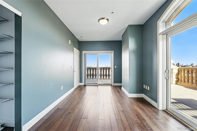 1950 N Logan St Unit 1109, Denver, CO 80203 - unfurnished room with wood finished floors and baseboards
