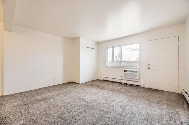 unfurnished room featuring carpet, an AC wall unit, and baseboard heating