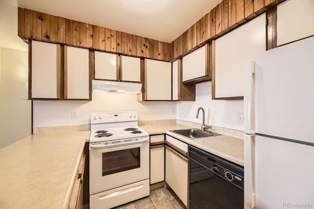 kitchen featuring white appliances, white cabinets, light countertops, under cabinet range hood, and a sink