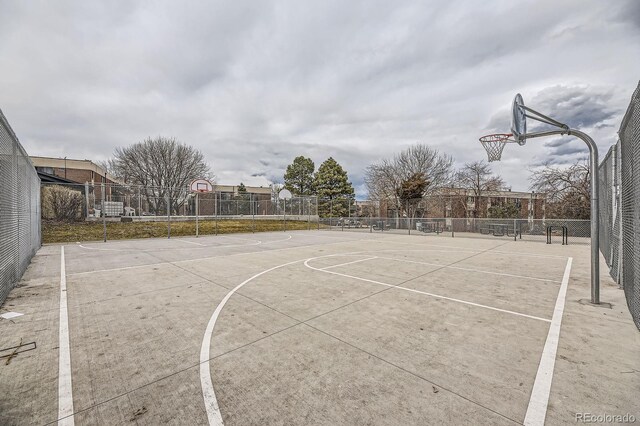 view of basketball court featuring community basketball court and fence