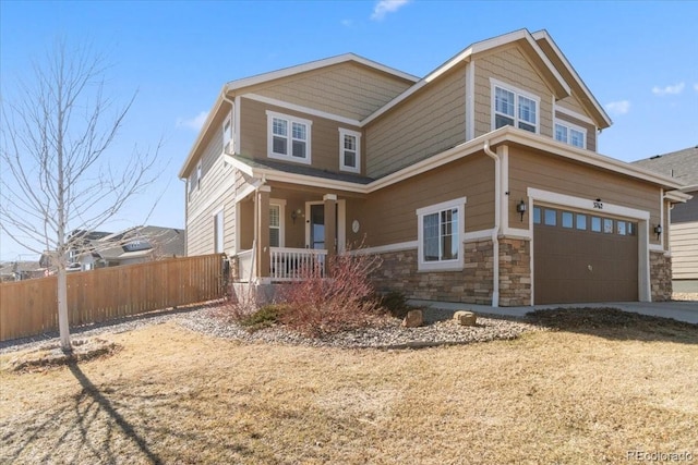 craftsman-style house featuring an attached garage, stone siding, fence, and a porch