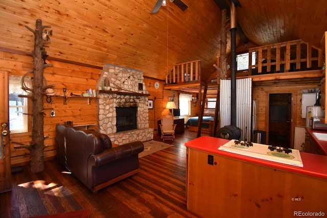 988 15th Trl, Cotopaxi, CO 81223 - living area with wooden ceiling, wood walls, a stone fireplace, and high vaulted ceiling