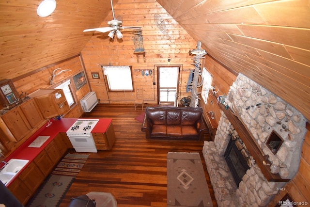 988 15th Trl, Cotopaxi, CO 81223 - living area with lofted ceiling, wood finished floors, a fireplace, wooden walls, and a ceiling fan