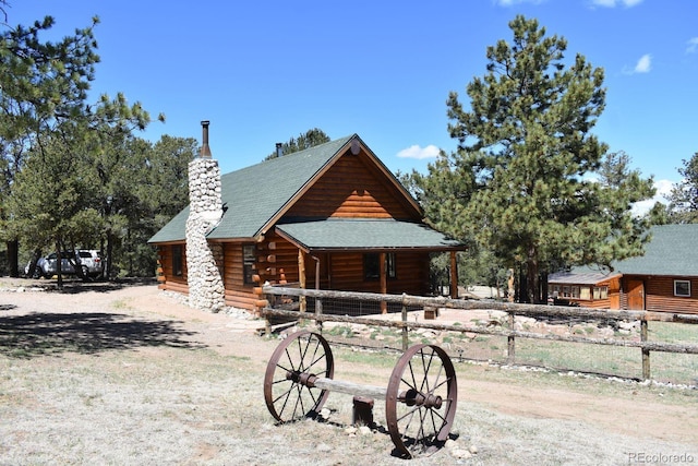 988 15th Trl, Cotopaxi, CO 81223 - cabin featuring a porch, log siding, fence, and a chimney