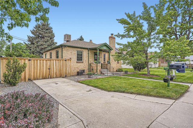 5704 Ammons St, Arvada, CO 80002 - view of front facade with brick siding, a chimney, and a shingled roof