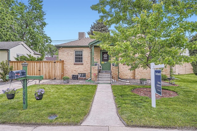 5704 Ammons St, Arvada, CO 80002 - view of front facade featuring brick siding, entry steps, and roof with shingles
