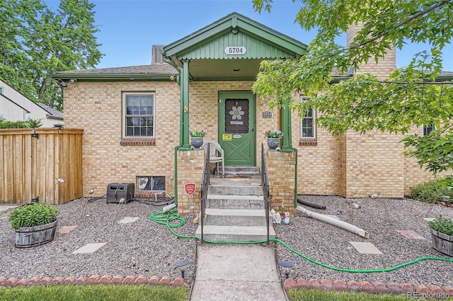5704 Ammons St, Arvada, CO 80002 - doorway to property featuring brick siding