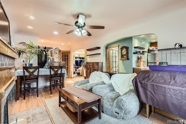 5704 Ammons St, Arvada, CO 80002 - living room featuring arched walkways, a ceiling fan, wood finished floors, and recessed lighting