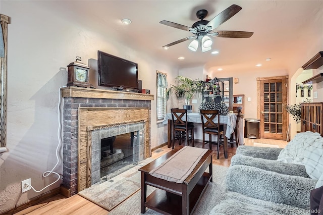 5704 Ammons St, Arvada, CO 80002 - living room featuring a ceiling fan, wood finished floors, a fireplace, and recessed lighting