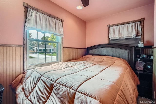 5704 Ammons St, Arvada, CO 80002 - bedroom with wainscoting, wooden walls, recessed lighting, and a ceiling fan