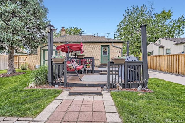5704 Ammons St, Arvada, CO 80002 - back of property featuring a deck, a chimney, roof with shingles, and brick siding